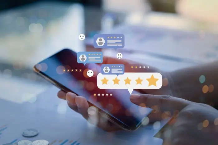 Smartphone with floating five-star ratings and review bubbles representing customer reviews