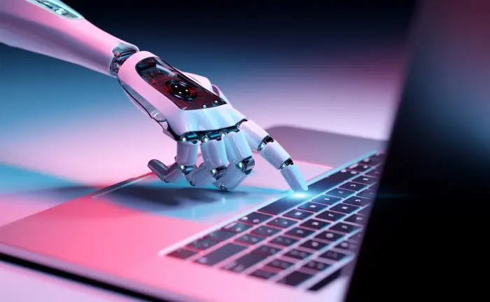 Robotic hand pressing a laptop keyboard, illustrating AI in digital marketing